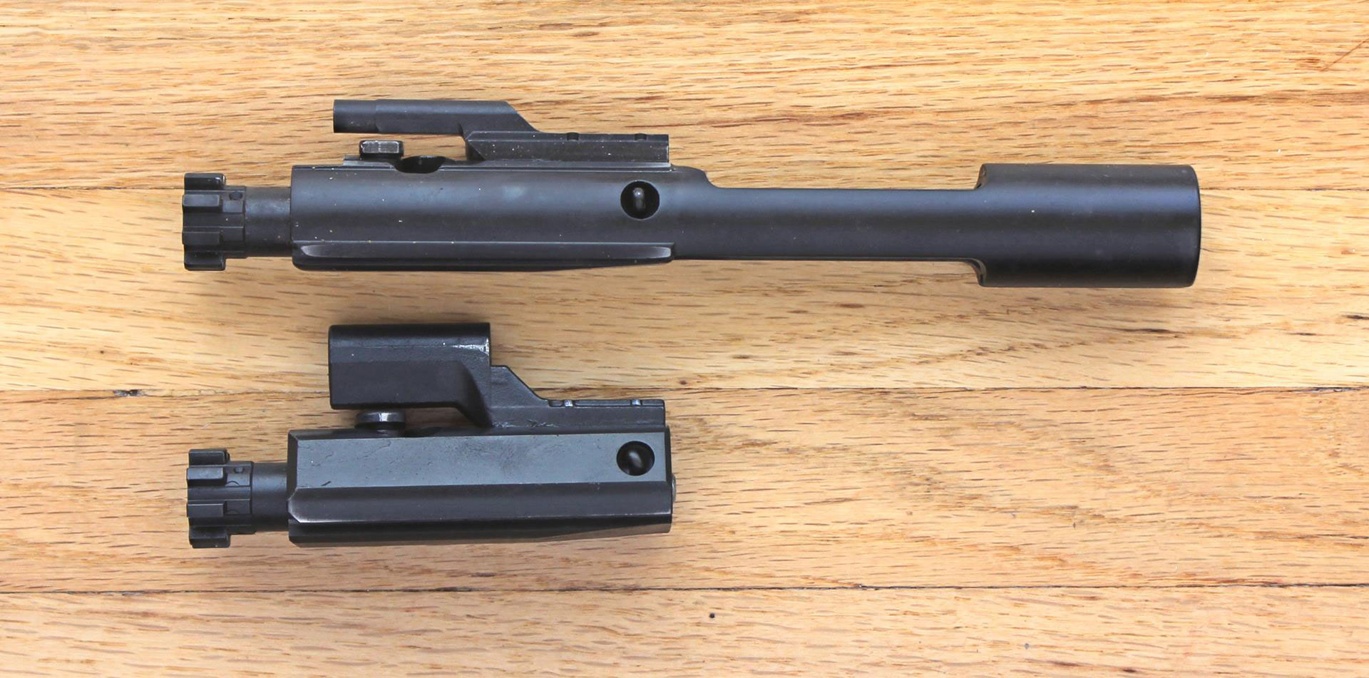 A typical AR-15 BCG (Top) compared to the FM-15 BCG (Bottom).