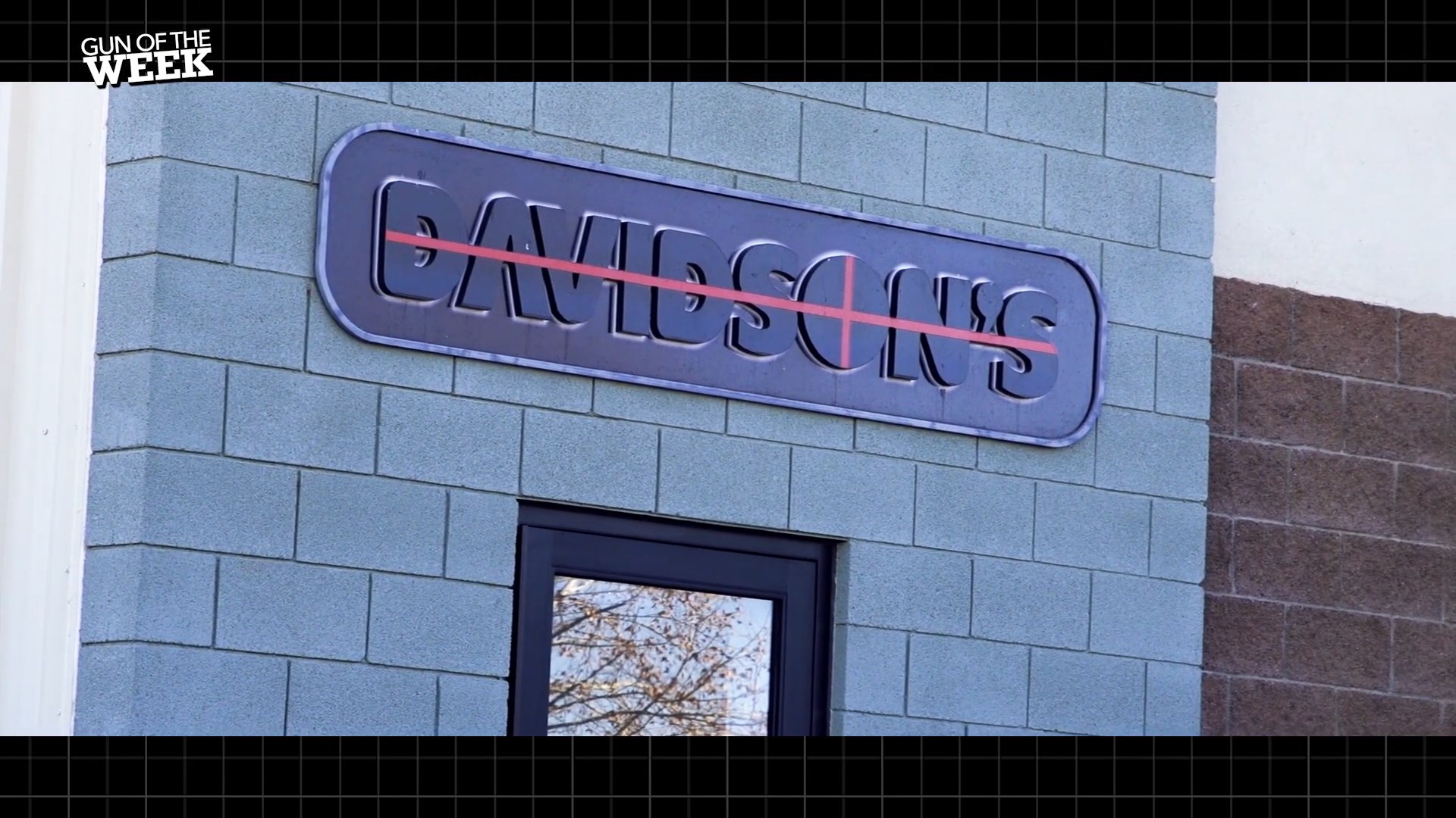 TEXT ON IMAGE GUN OF THE WEEK DAVIDSON's banner on concrete block brick building store front with door