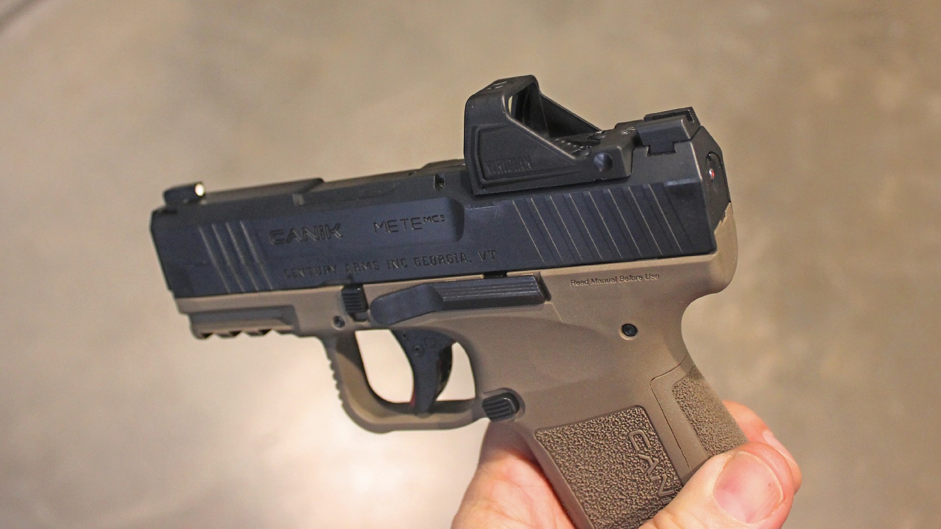 Canik Mete MC9 pistol in hand shown with red-dot optic viridian rfx11