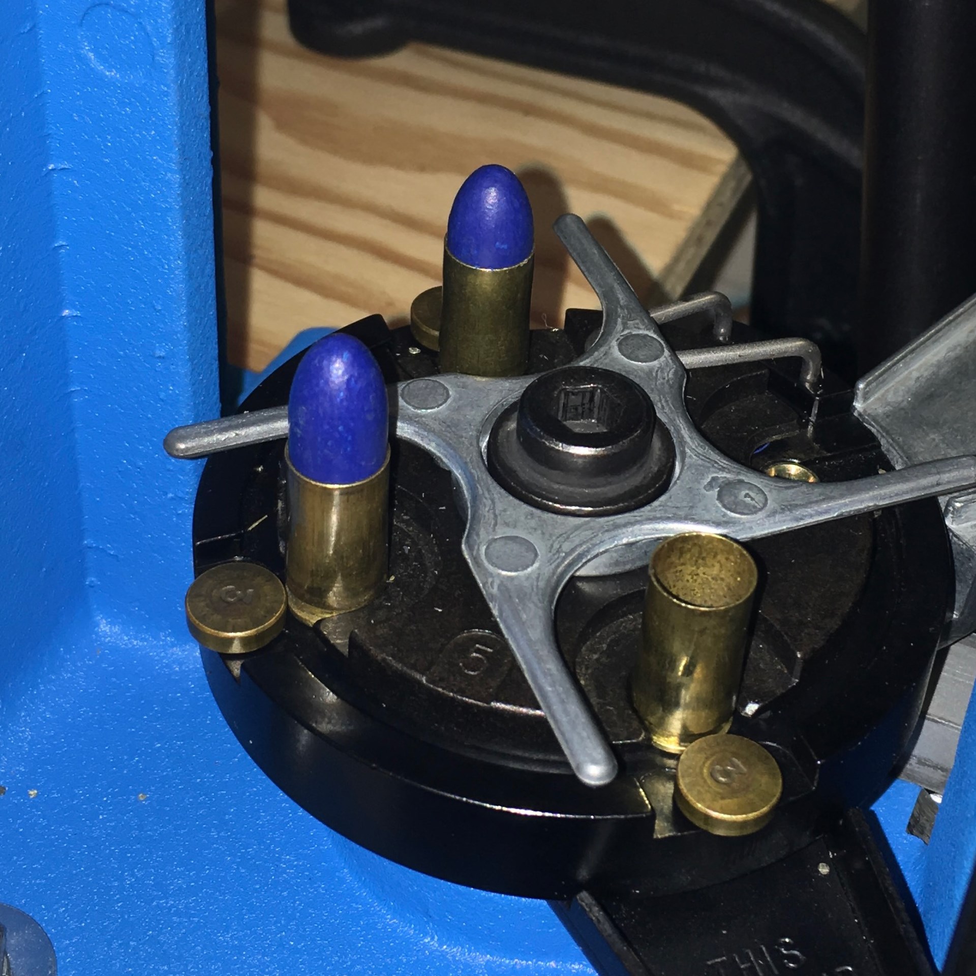 Dillon reloading press plate with ammunition bullets brass cases blue coated bullets