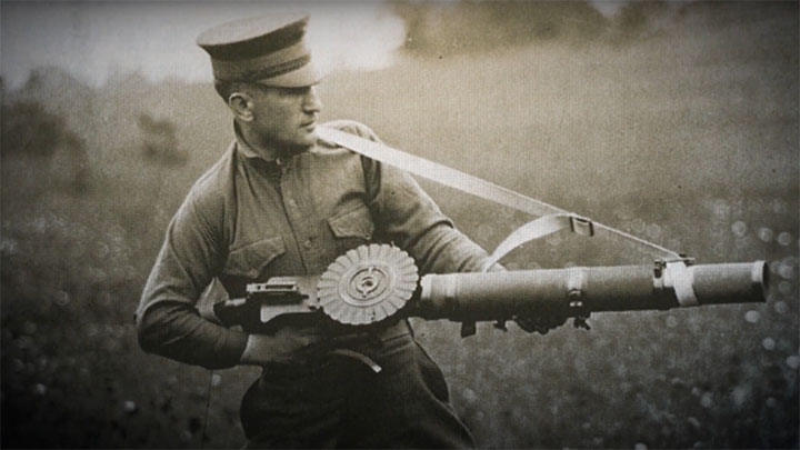 A soldier demonstrating use of the Lewis Light Machine Gun from the hip using a sling.