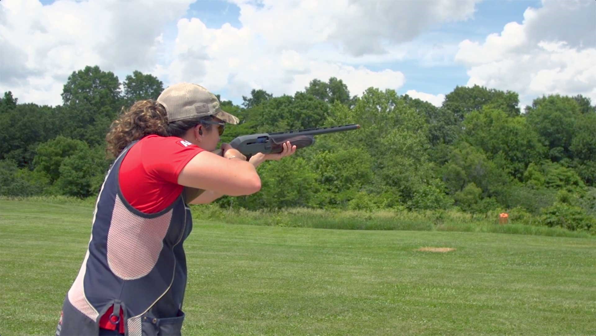 Team Winchester shooter Desirae Edmunds aims a shotgun into a field.
