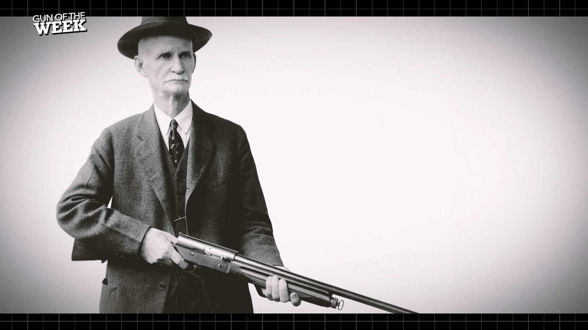 John Moses Browning in three-piece suit and hat holding Auto-5 semi-automatic shotgun text on image noting GUN OF THE WEEK
