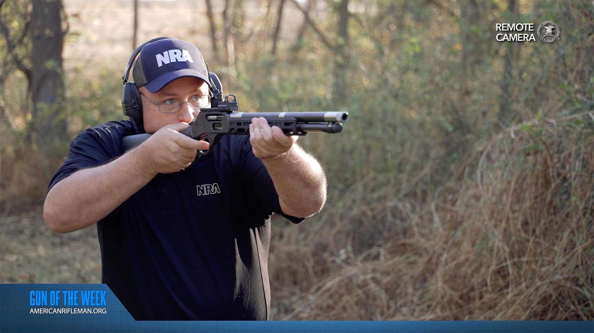 Man aiming a Henry Repeating Arms HUSH lever-action rifle on an outdoor range.