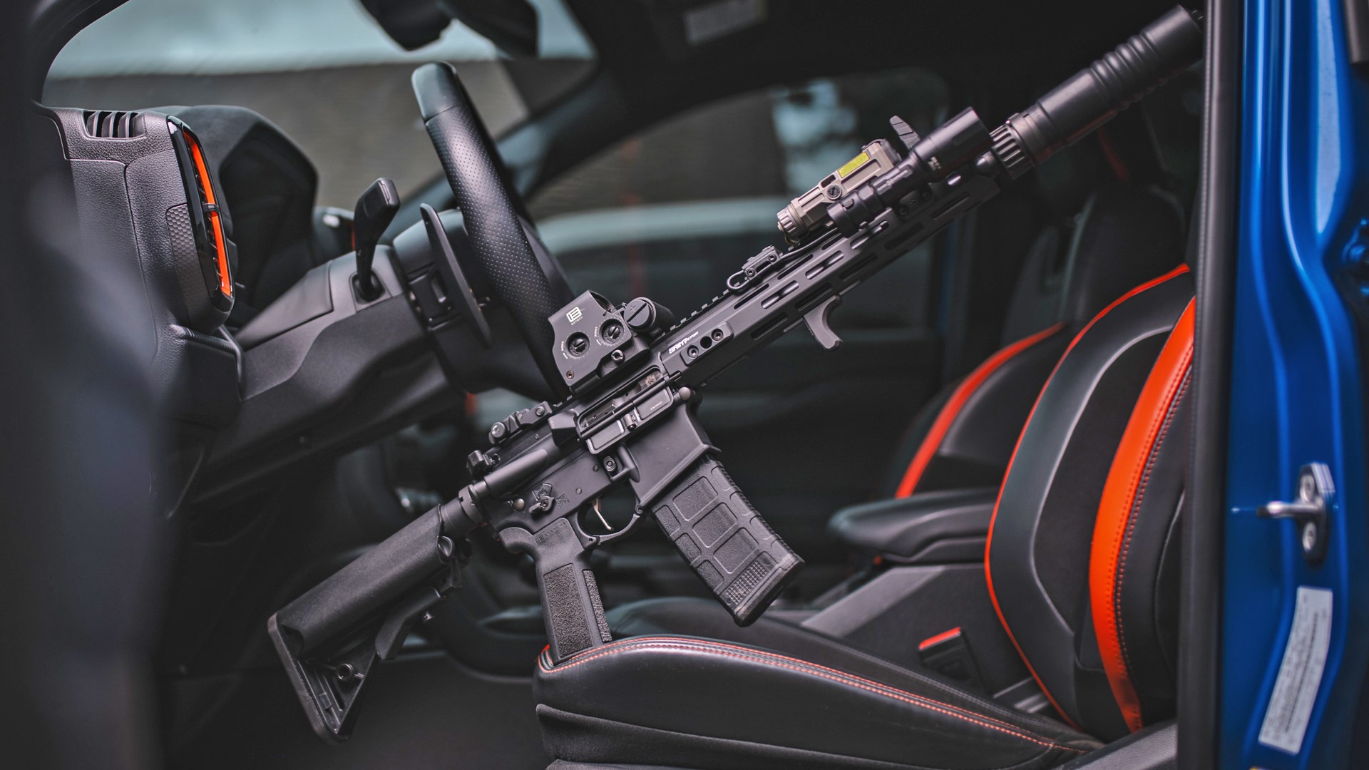 Springfield Armory Saint Victor AR-15 propped up on the driver's seat of a car.