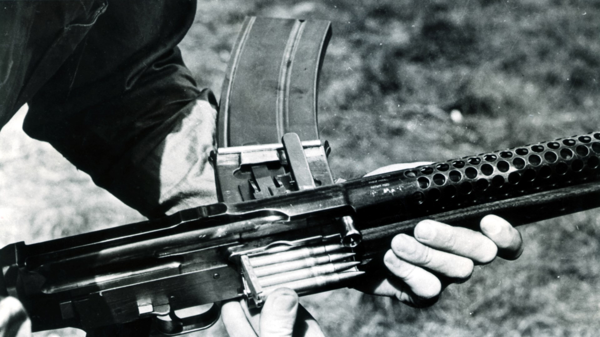 Melvin Johnson demonstrating the Johnson LMG during the summer of 1940. The firearm could be loaded by stripper clips at the ejection port, or single rounds could be loaded into the breech. Author’s collection