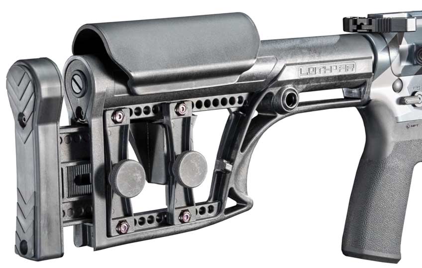 gun stock black plastic metal knobs white background