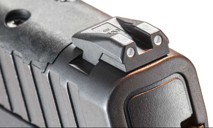 Combat-style rear sight on top of Masada pistol on white background.