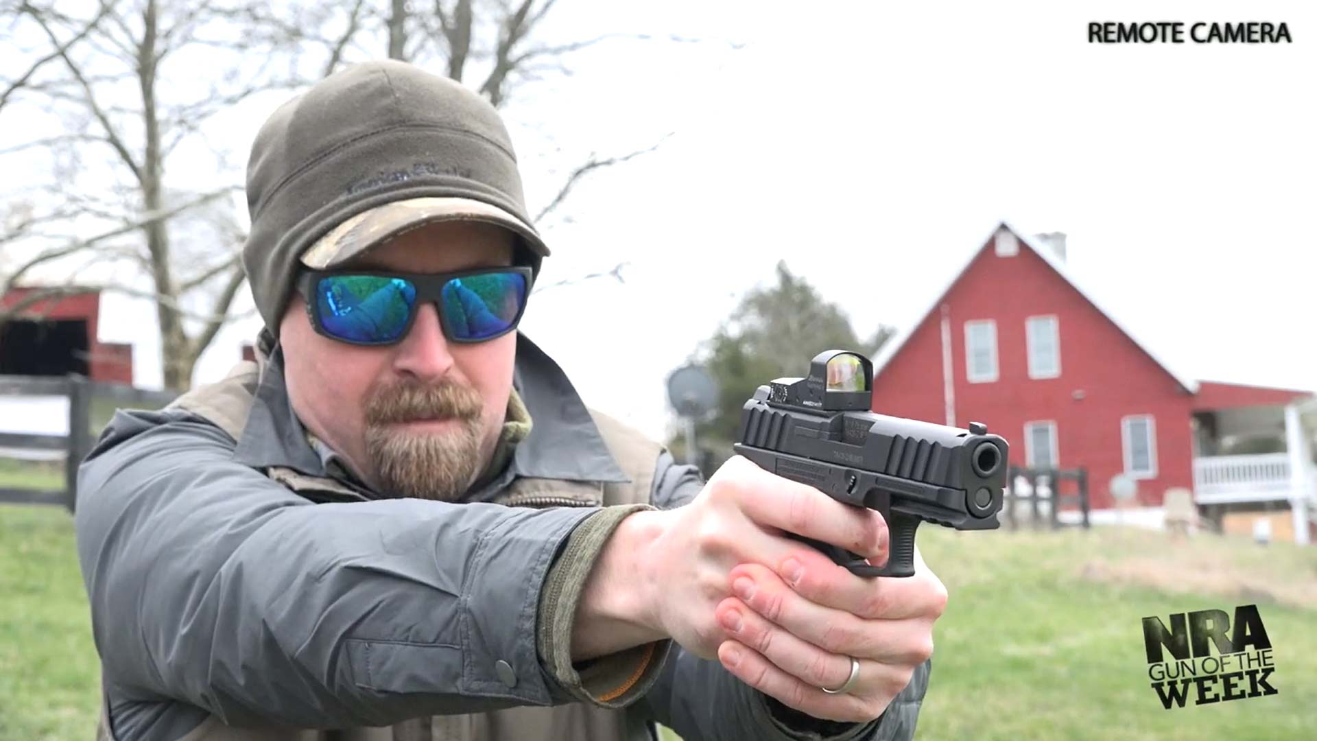 Man outdoors cold winter gear shooting pistol stoeger str-9c