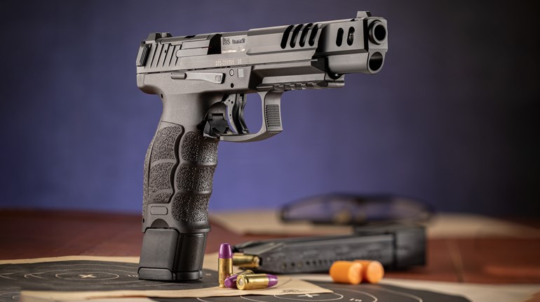 Heckler & Koch VP9 Match 9 mm handgun shown with target magazine ammunition bullseye blue background