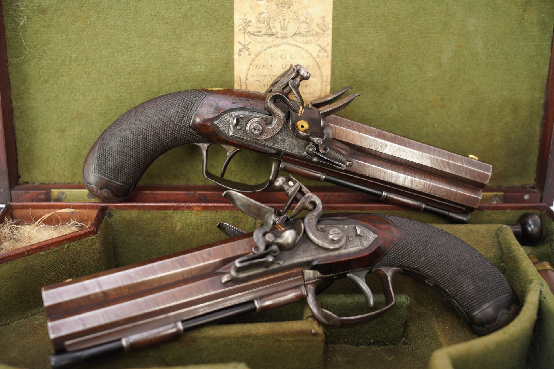 This cased pair of Durs Egg presentation over/under .48 caliber flintlock pistols dates from 1820-30.
