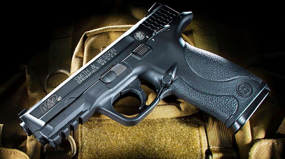 black pistol handgun hook and loop smith and wesson dark background ominous