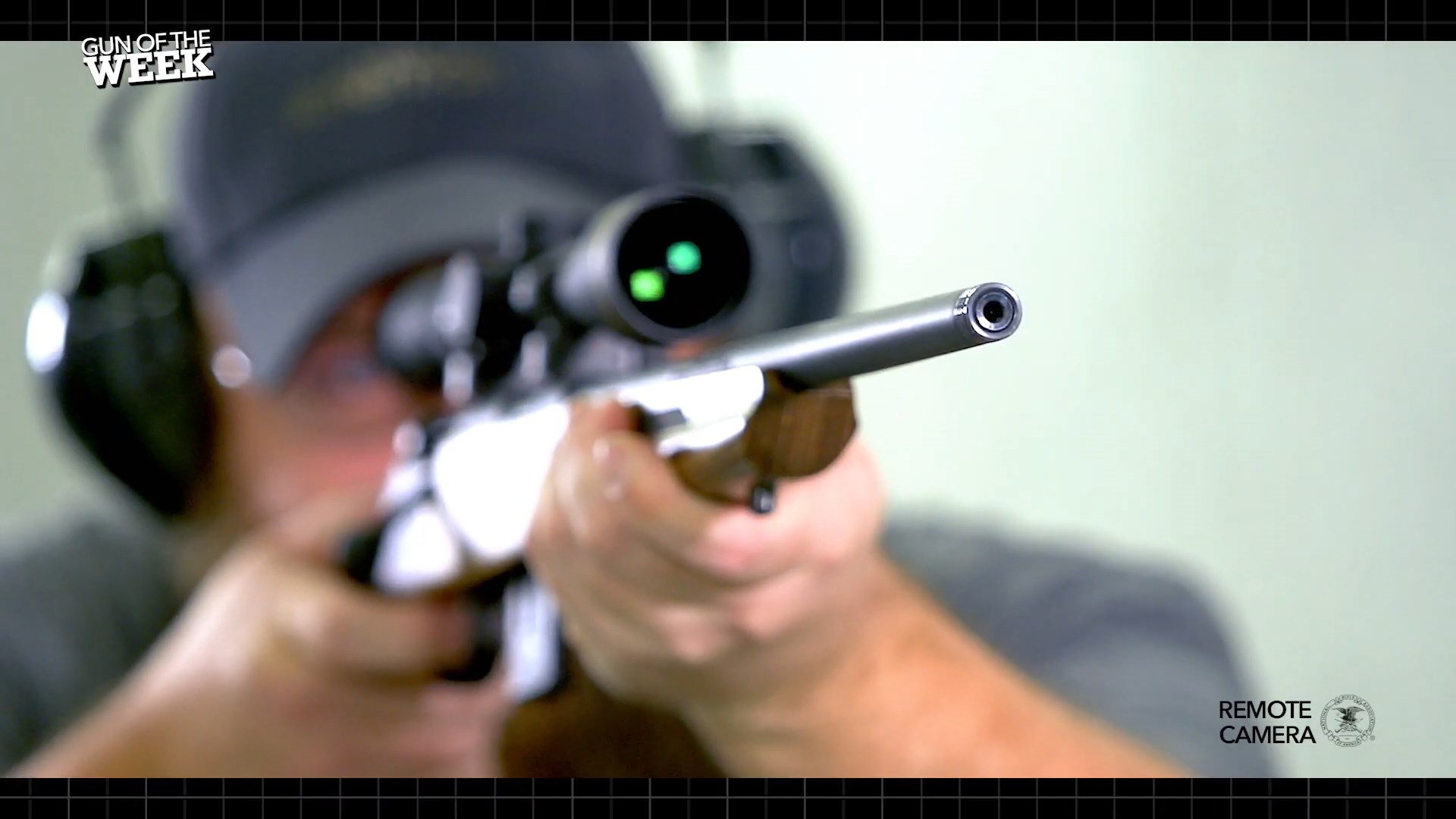 Savage 93 Minimalist bolt-action rifle on shooting range man ear protection ballcap gun indoors remote camera gun of the week text