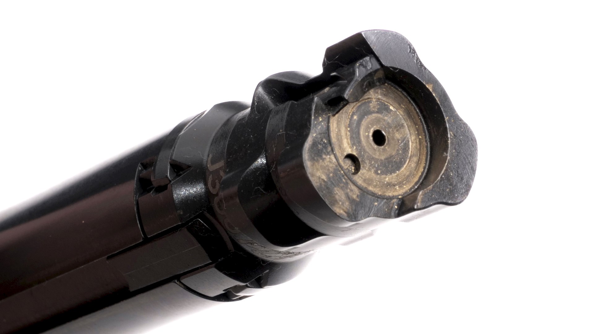 CZ 600 rifle bolt closeup on white background black metal tri-lug face circular indent for cartridge casehead with copper brass color residue visible extractor ejector and firing pin hole