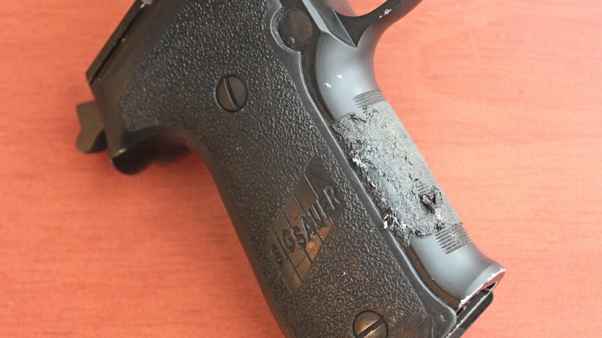 SIG Sauer P226 grip frame shown with adhesive leftover from tape