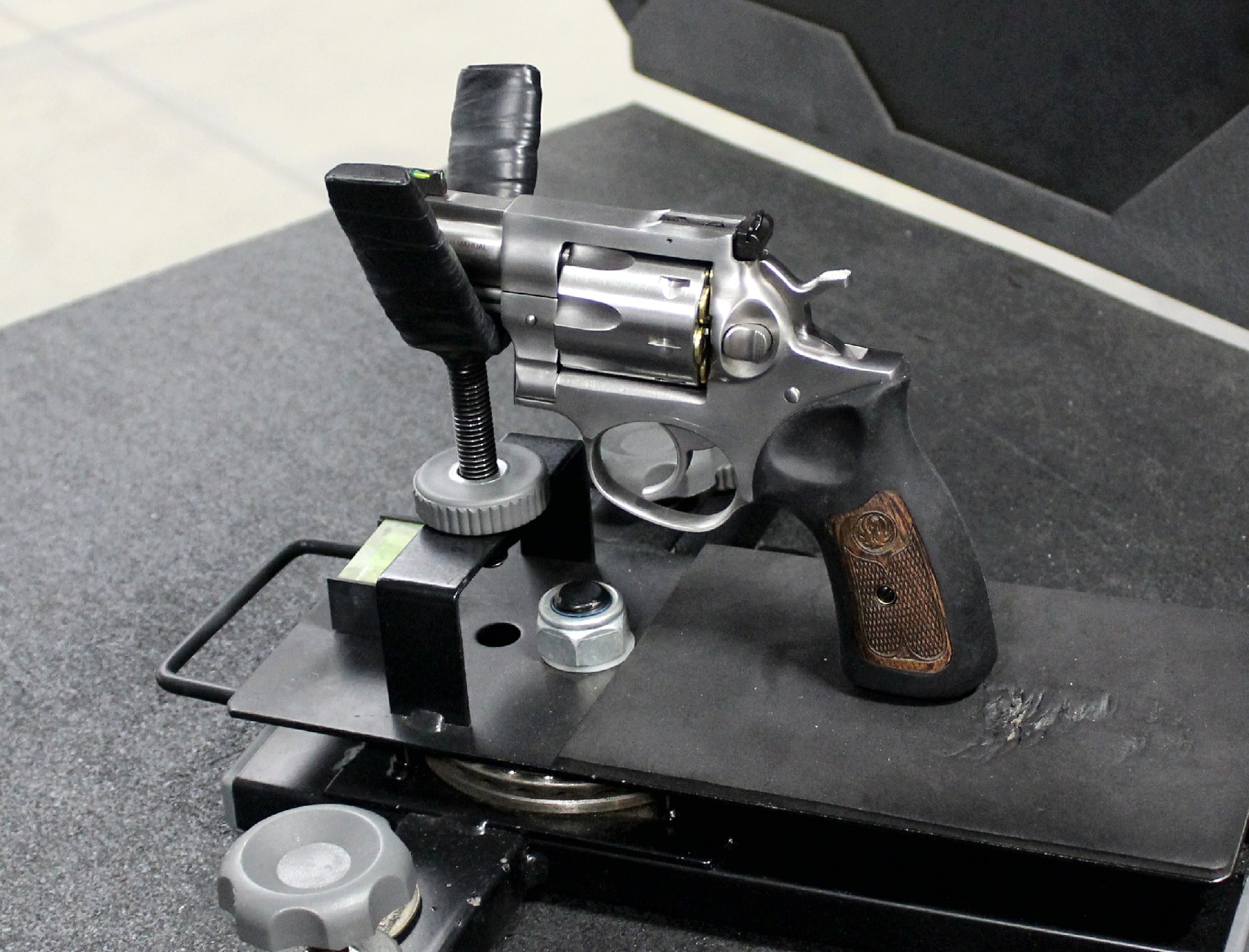 Ruger GP-100 7-shot revolver stainless steel gun on table bench rest target shooting range black table