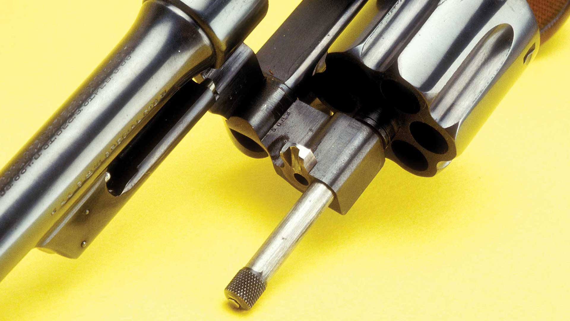 yellow background steel metal shiney gloss parts cylinder gun revovler