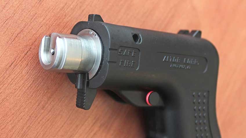 An angled view of the front of the Altor bolt face and lugs with the barrel removed. The pistol is on a wood tabletop.