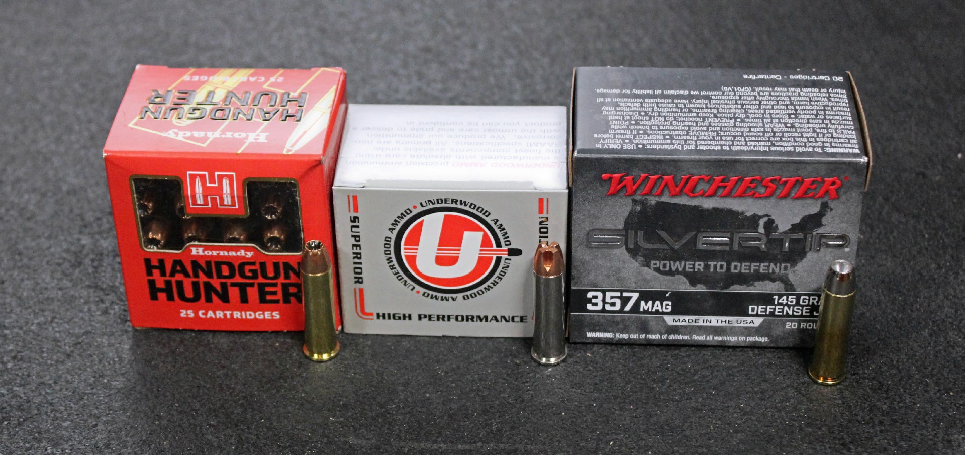 .357 Magnum ammunition three boxes bullets row arrangement dark background