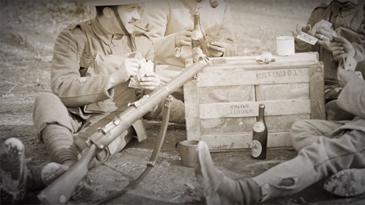 Soldiers sitting around a crate with a No.1 MkIII* SMLE in the foreground.