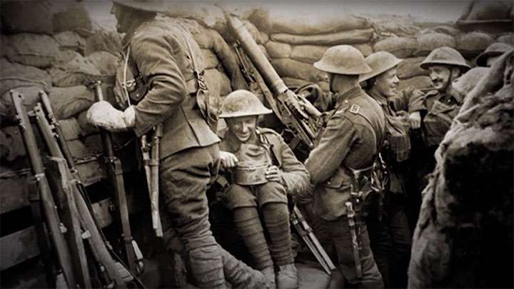 Soldiers packed into a trench on the Western Front surrounded by SMLE rifles and with a Lewis Light Machine Gun.