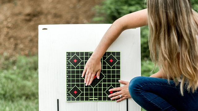 Woman covering rifle target