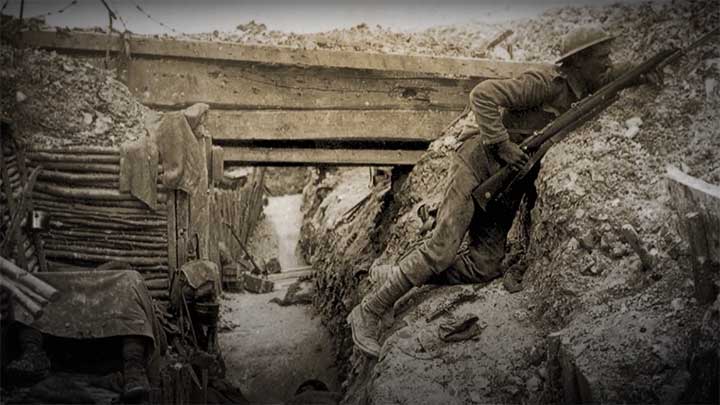 An example of the conditions inside the trenches during World War I with a British soldier cautiously looking over the top.