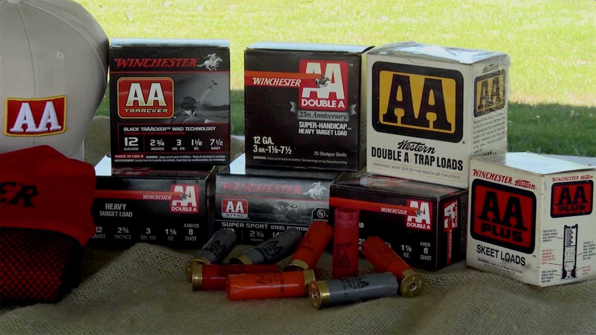 Winchester AA shotshell boxes on a table with empty shotshell hulls in the foreground.