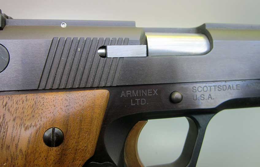 Showing the right side of the slide on the Arminex TriFire, featuring the extractor and the slide serrations.