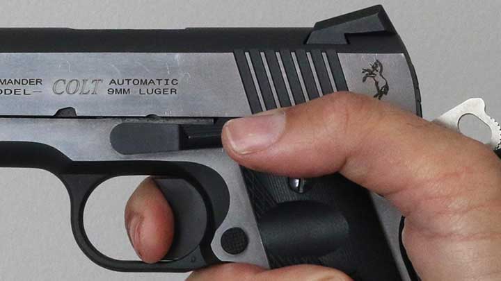 A close up of finger placement on the 1911 trigger.