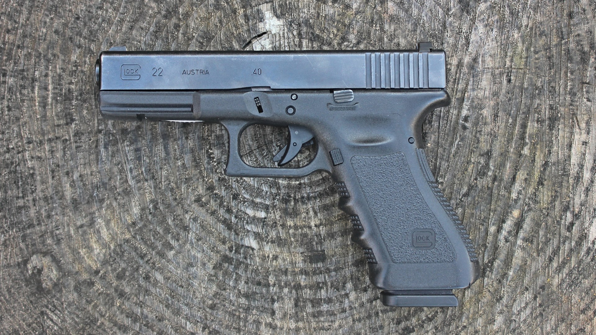 Glock Gen3 G22 left-side on log