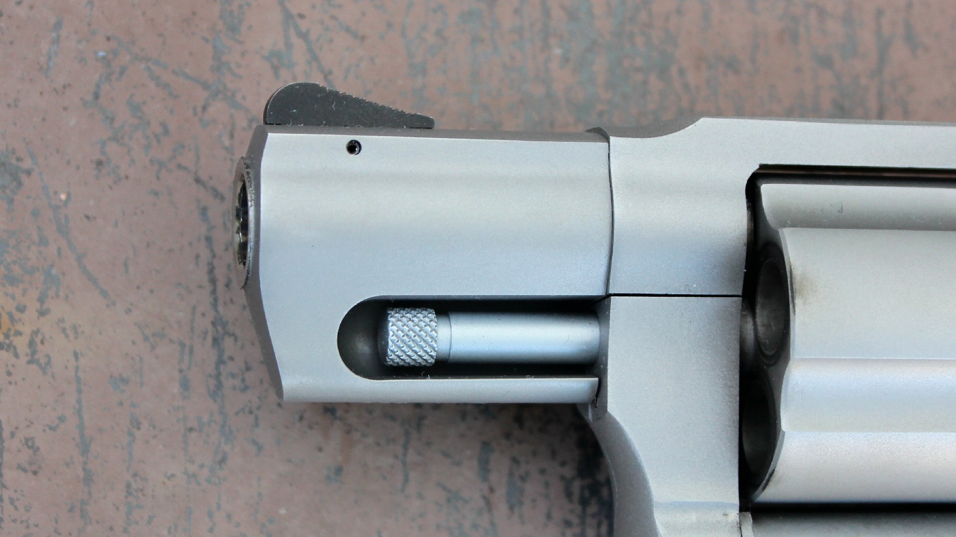 Left side of the Taurus 605 revolver's barrel and shrouded ejector rod.