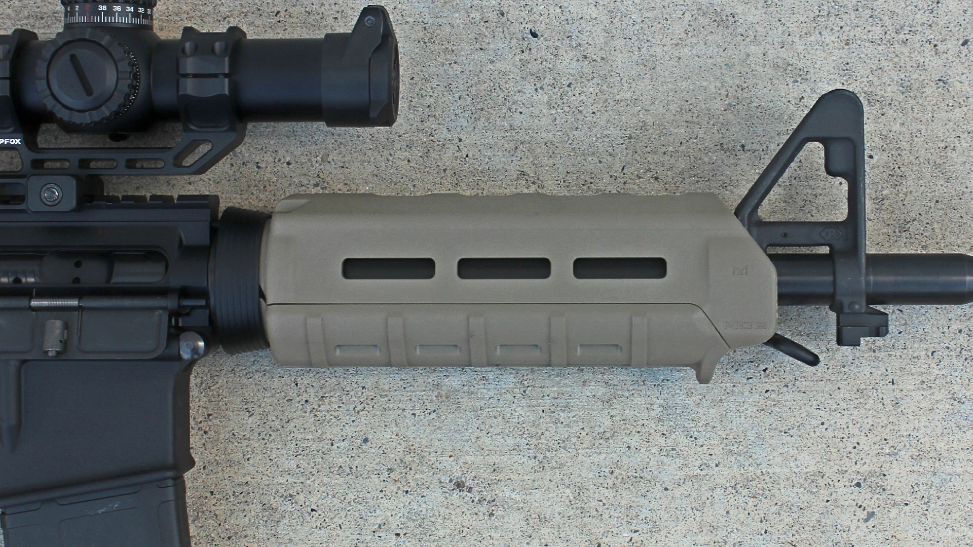 Palmetto State Armory PA-15 carbine right-side view closeup Magpul FDE MOE handguard A2 sight shown on concrete floor