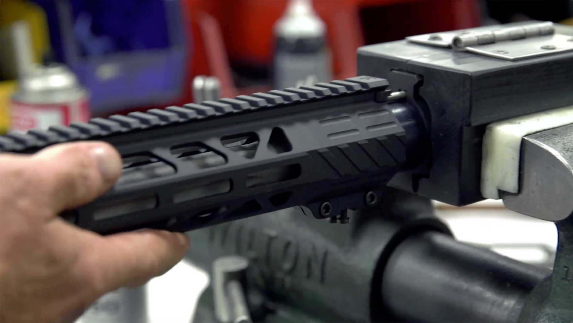 An AR-15 handguard being assembled onto a rifle at Rock River Arms.