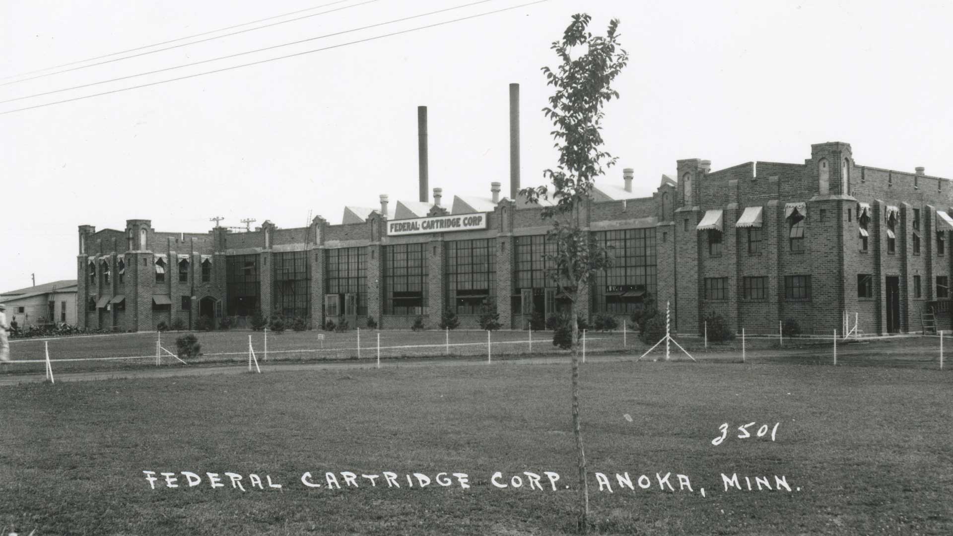 vintage photo factory building brick black and white gray color outdoors grass trees