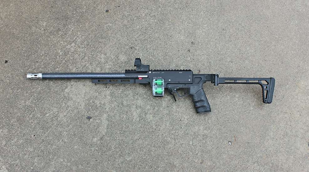 Left-side view of a custom tandemcross manticore 22 lr repeating rifle shown on concrete floor
