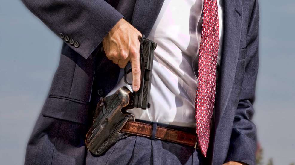 Man suit tie handgun pistol drawing concealment concealed carry leather holster semi-automatic black pistol