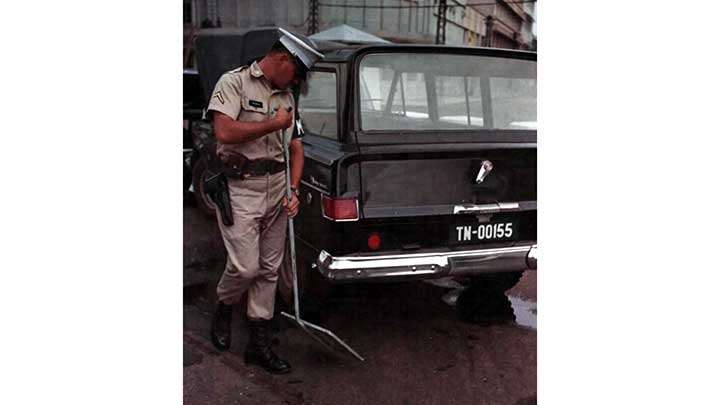 Defense against terrorists:  A US guard checks inbound traffic at the US embassy in Saigon in 1965.