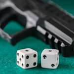 pistol with snake eyes dice